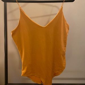 Burnt yellow body suit.